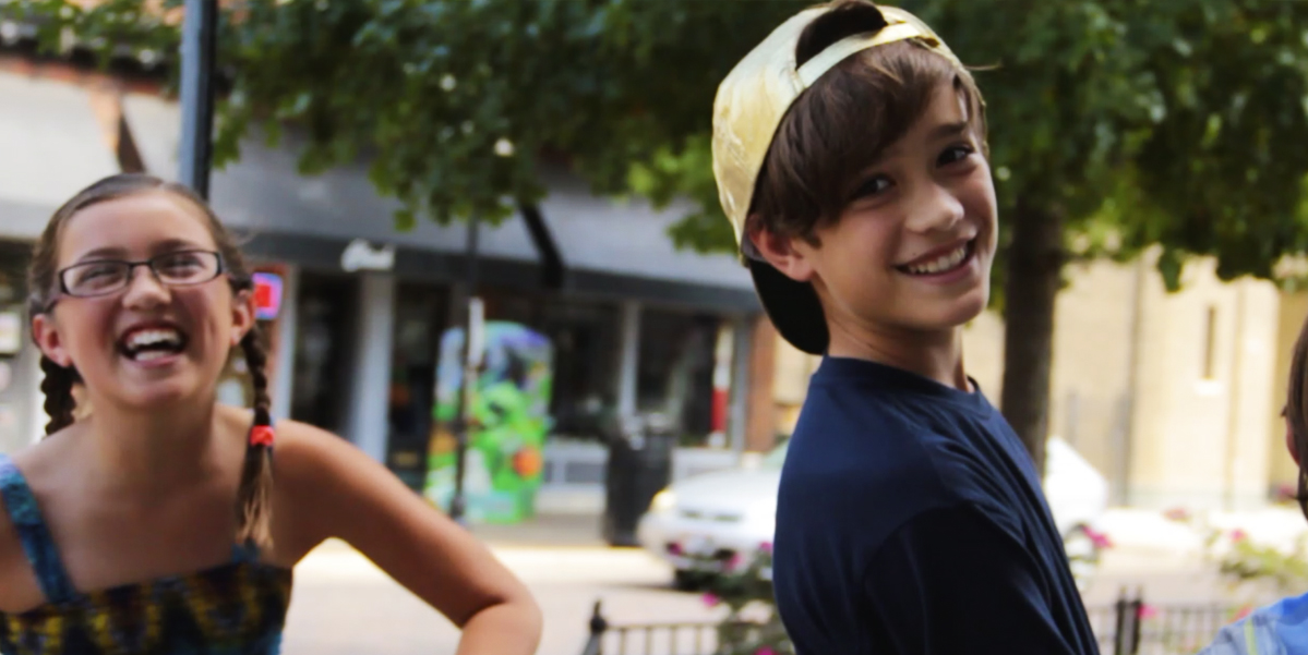 two children (Jett and Aamah) smiling at the camera in downtown dayton